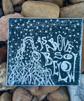 As Above, So Below — Black & White Linocut Print featuring intricate celestial and root imagery with stylized white lettering on black watercolor paper, embodying dark feminine aesthetic.
