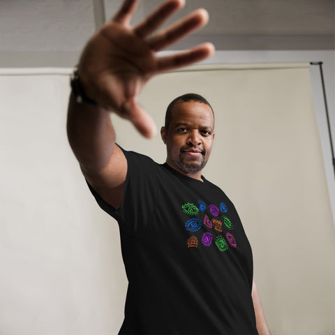 Man wearing a black premium heavyweight fabric t-shirt with colorful symbolic eye graphics, extending his hand forward, showcasing the All Eyes On Me Tee.