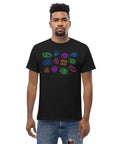 Man wearing a black "All Eyes On Me Tee" made of premium heavyweight fabric, featuring colorful graphic eyes in blue, green, purple, and orange across the chest, styled with casual ripped jeans.