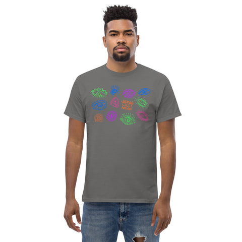 Man wearing a charcoal "All Eyes On Me Tee" made of premium heavyweight fabric featuring a colorful array of abstract eye designs across the chest, styled in a dark feminine aesthetic.