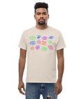 Man wearing an off-white premium heavyweight fabric "All Eyes On Me Tee" featuring colorful abstract eye designs in blue, green, and pink across the chest, styled in a casual look with ripped denim jeans.