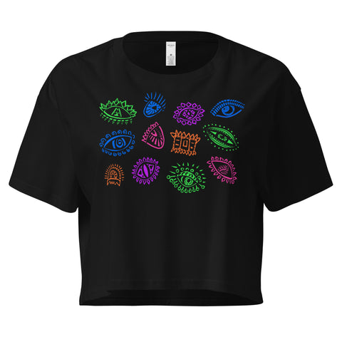 Black All Eyes on Me Crop Top made from lightweight 100% combed cotton featuring colorful abstract eye illustrations arranged across the chest in a relaxed, cropped fit.