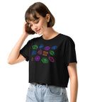 A woman wearing the black All Eyes on Me Crop Top featuring colorful eye and symbol designs, paired with light blue high-waisted jeans, styled with a relaxed, dark feminine aesthetic.