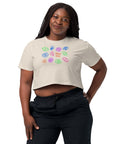 Woman wearing a relaxed fit, 100% combed cotton All Eyes on Me Crop Top with colorful eye and symbolic designs on the front, paired with black pants.