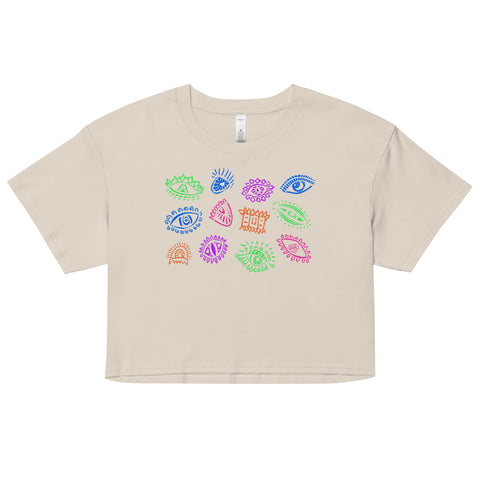 All Eyes on Me Crop Top in soft, lightweight combed cotton featuring colorful, whimsical eye symbols arranged in a playful pattern on a relaxed fit, cropped beige fabric.