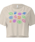 Beige lightweight All Eyes on Me Crop Top featuring colorful, whimsical eye illustrations in shades of green, blue, pink, purple, and orange, designed with a relaxed, cropped fit.