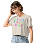 Woman wearing a relaxed fit, lightweight All Eyes on Me Crop Top in soft beige featuring colorful symbolic eye illustrations, paired with casual light-wash jeans.