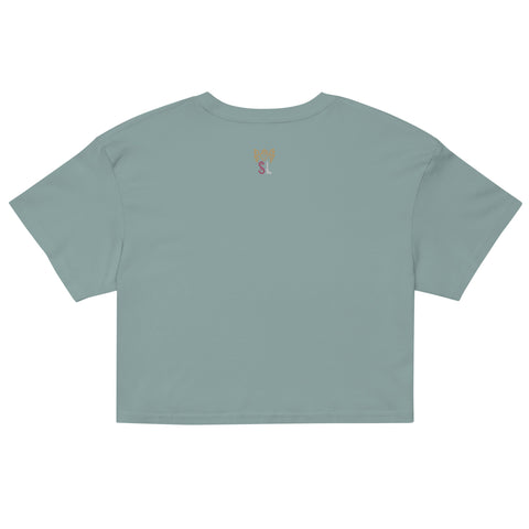 Back view of As Above, So Below Crop Top (White) in soft, lightweight combed cotton with a relaxed fit and cropped length, styled in a muted sage green tone.