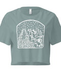 As Above, So Below Crop Top (White) in soft combed cotton with a relaxed fit, featuring a mystical white celestial design on a muted sage green background.